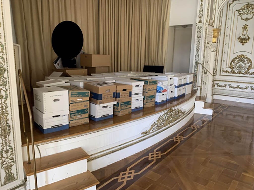 Boxes of documents are stacked onstage at Mar-a-Lago