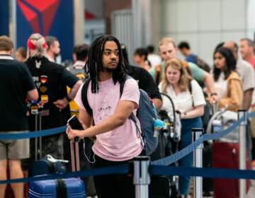 A traveler waits in line at the airport.