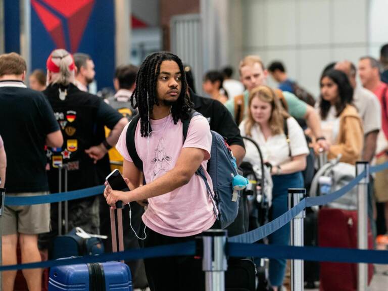 A traveler waits in line at the airport.