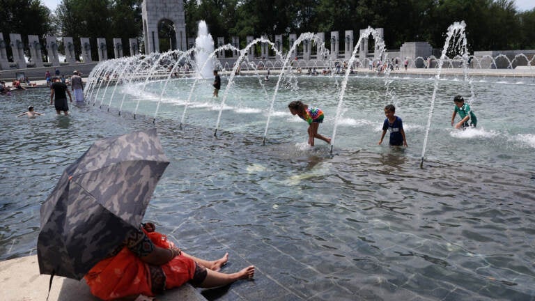 Kids play in a fountain.