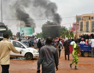 A general view of billowing smoke as supporters of Niger's defense and security forces attack the headquarters of the Nigerien Party for Democracy and Socialism, the party of overthrown President Mohamed Bazoum, in Niamey, Thursday.