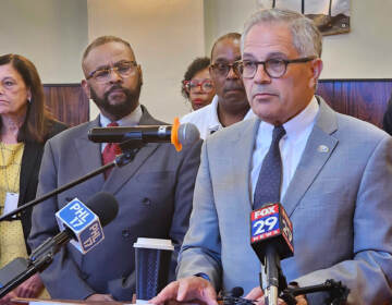 Larry Krasner speaking at a podium