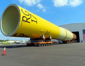 A huge foundation for an offshore wind turbine, called a monopile, sits atop wheeled movers in Paulsboro, N.J.