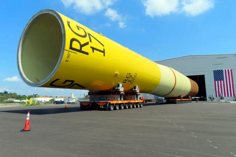 A huge foundation for an offshore wind turbine, called a monopile, sits atop wheeled movers in Paulsboro, N.J.