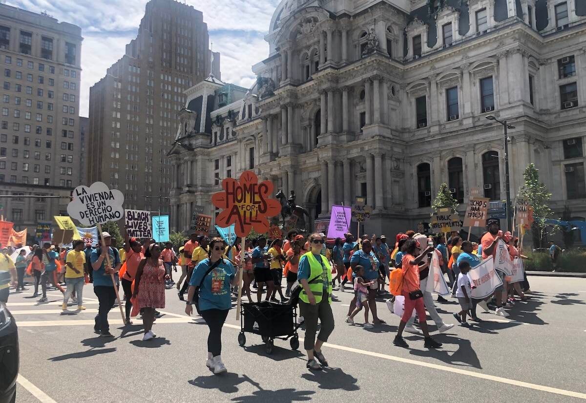 People march in front of City Hall in Philadelphia, demanding affordable housing for all.