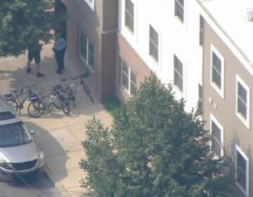 An aerial view of houses and people on a sidewalk.