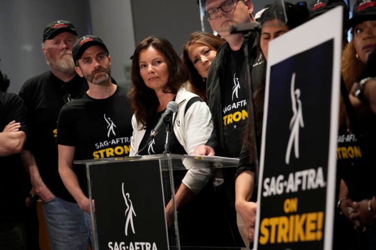 SAG-AFTRA president Fran Drescher, center, and SAG-AFTRA National Executive Director and Chief Negotiator Duncan Crabtree-Ireland, center right speak alongside SAG-AFTRA members during a press conference announcing a strike by The Screen Actors Guild-American Federation of Television and Radio Artists on Thursday, July, 13, 2023, in Los Angeles.