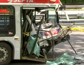 Smashed front section of a bus after a crash