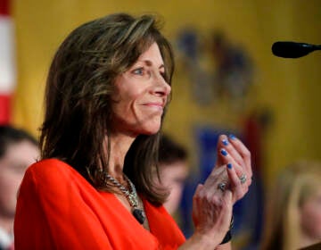 Tammy Murphy smiles as she claps.