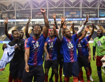 Team Liberia celebrating on the field.