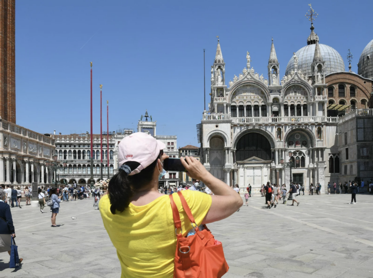 A tourist looking at St. Mark's basillica.