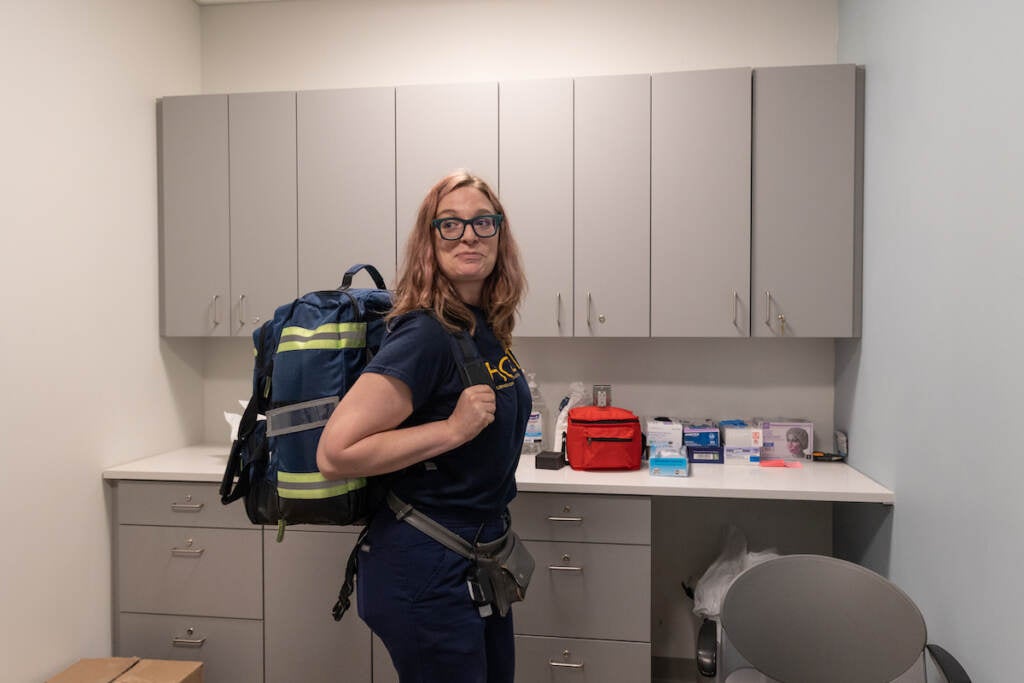 Kara Cohen poses for a photo while wearing a backpack