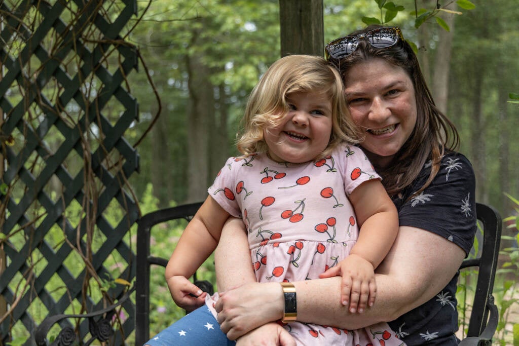 Meghan Jones and her daughter Lily, 2, smile while posing for a photo