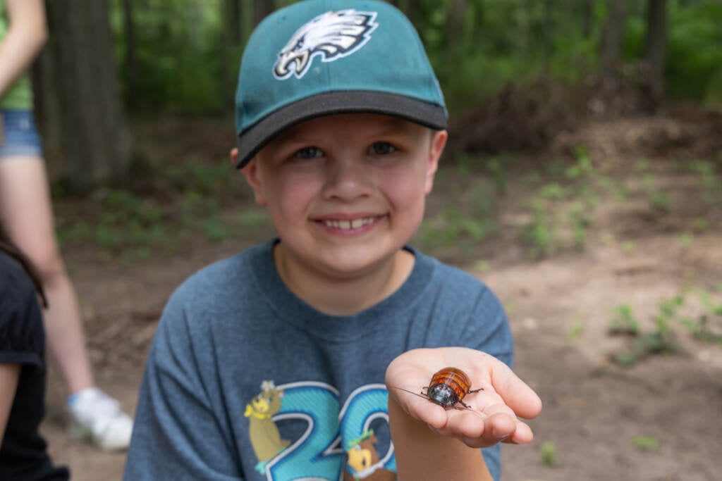 Michael Roames, 7, holds a hissing cockroach