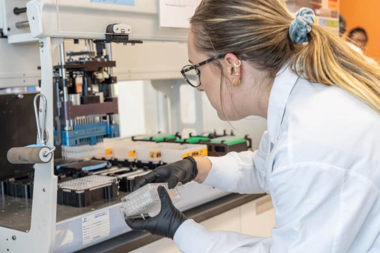 Biotech research associate Katie Bell in the lab at Integral Molecular in Philadelphia. (Kimberly Paynter/WHYY)