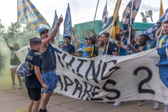 Philadelphia Union fan group Sons of Ben march and chant on their way into Subaru Park stadium in Chester, Pa. for the team’s semi-final match against Inter Miami on August 15, 2023. (Kimberly Paynter/WHYY)