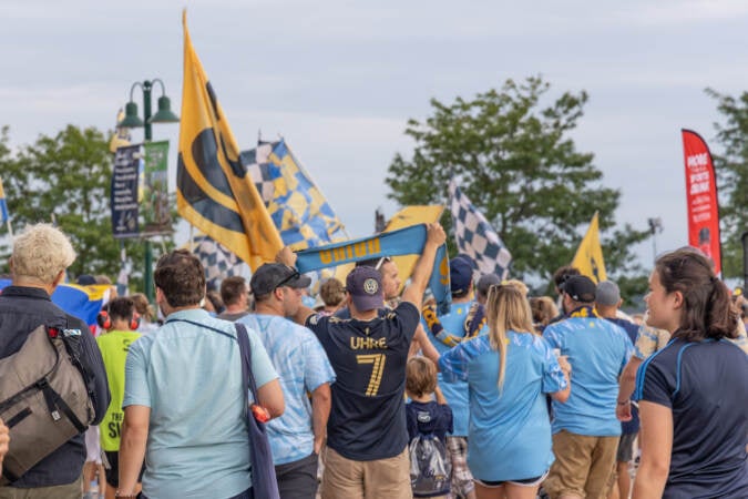 Fans of the Philadelphia Union march into Subaru Park stadium in Chester, Pa. for their semi-final match against Inter Miami on August 15, 2023. (Kimberly Paynter/WHYY)