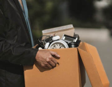 A man who has been fired or has resigned from their company walks out carrying boxes. (Big Stock/Charnchai Saeheng