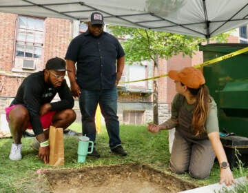 Penn anthropology student Autumn Melvin shares the day's finds with community activists Chris Burney (left) and James Wright.