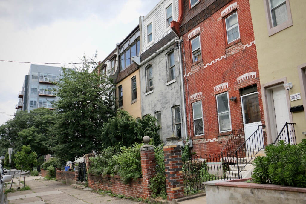 A block of rowhomes on Philadelphia's Warren Street is visible.