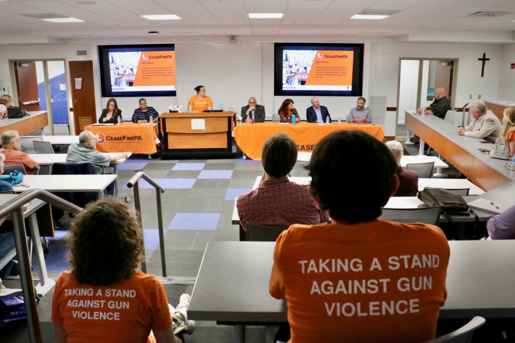 A view from the back of the room at a town hall meeting.