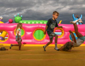 Children bounce through a space themed attraction during a press preview of Big Bounce America at the Philadelphia Navy Yard. (Emma Lee/WHYY)