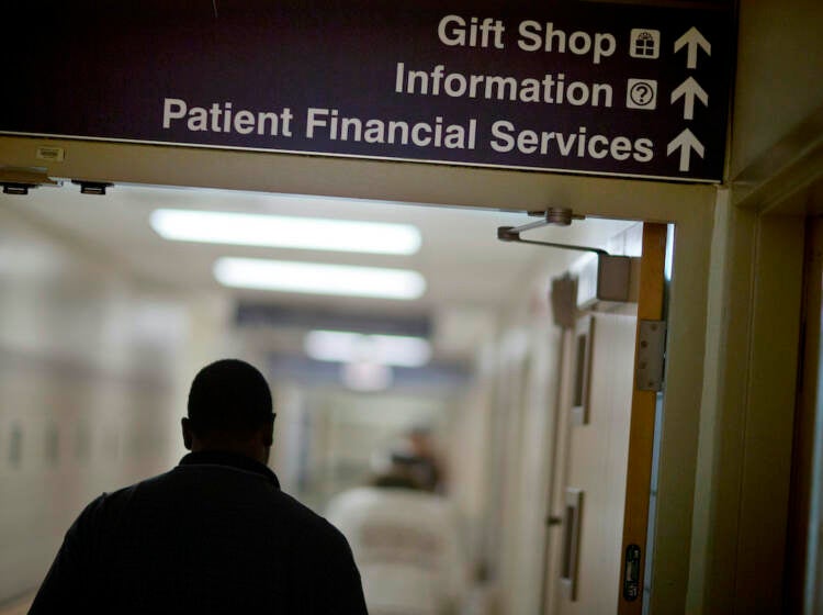 Congress Medicaid Work Requirements A sign points visitors toward the financial services department at a hospital.