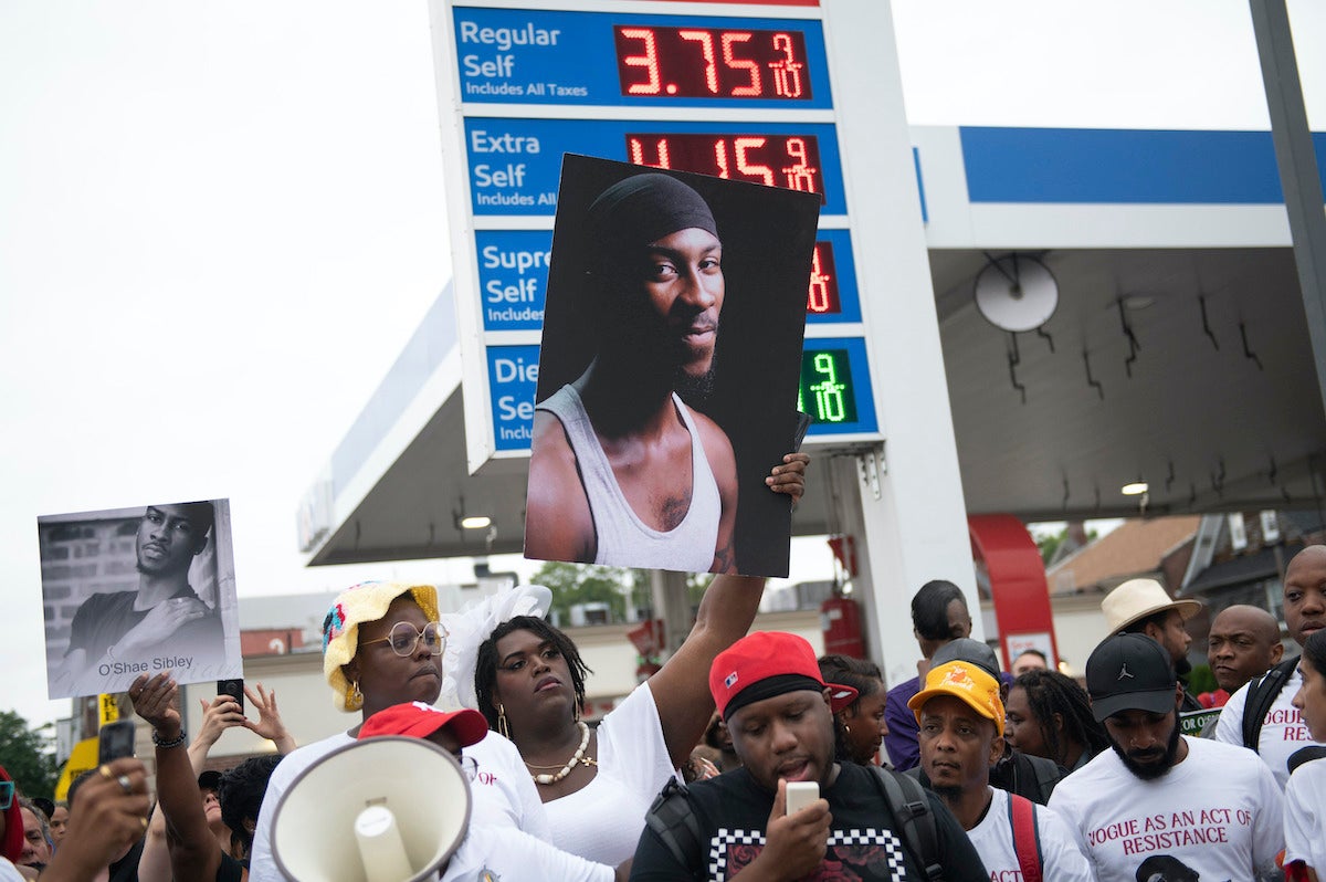 People gather at a gas station during a vigil to memorialize O'Shae Sibley on Friday, Aug. 4, 2023, in the Brooklyn borough of New York. Sibley, a gay man, was fatally stabbed at the gas station after a confrontation between a group of friends dancing to a Beyoncé song and several young men who taunted them