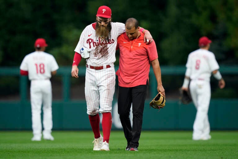 Philadelphia Phillies' Brandon Marsh is helped off the field after an injury during the fifth inning of a baseball game against the Kansas City Royals, Saturday, Aug. 5, 2023, in Philadelphia