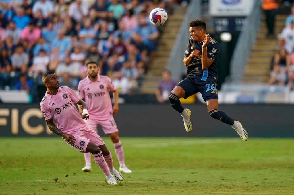 Philadelphia Union's Nathan Harriel, right, leaps for a head ball as Inter Miami's Dixon Arroyo, left, front left, watches during the first half of a Leagues Cup soccer semifinal 