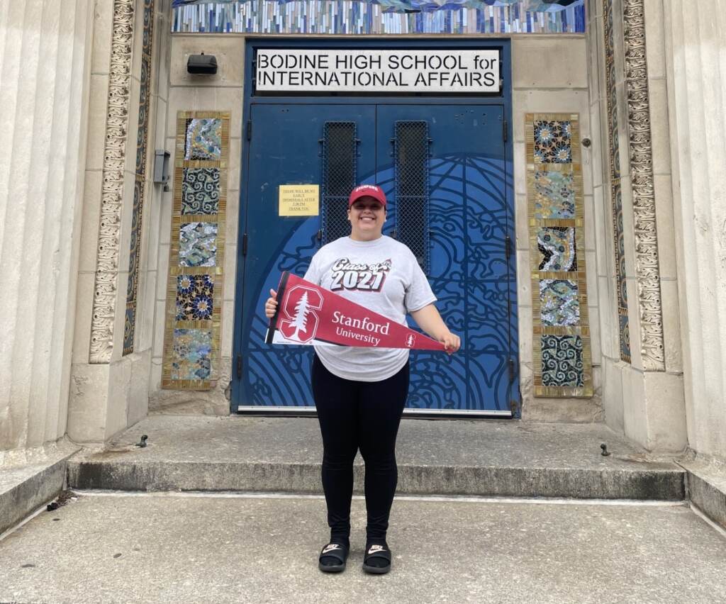 Alexianie Negron posing in front of her school.