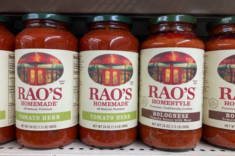 Bottles of tomato sauce on a supermarket shelf