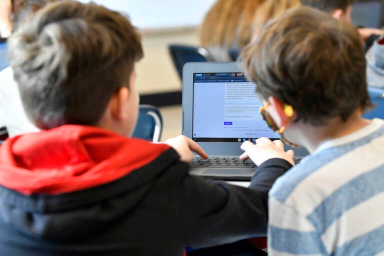 Students working on a computer together in a classroom