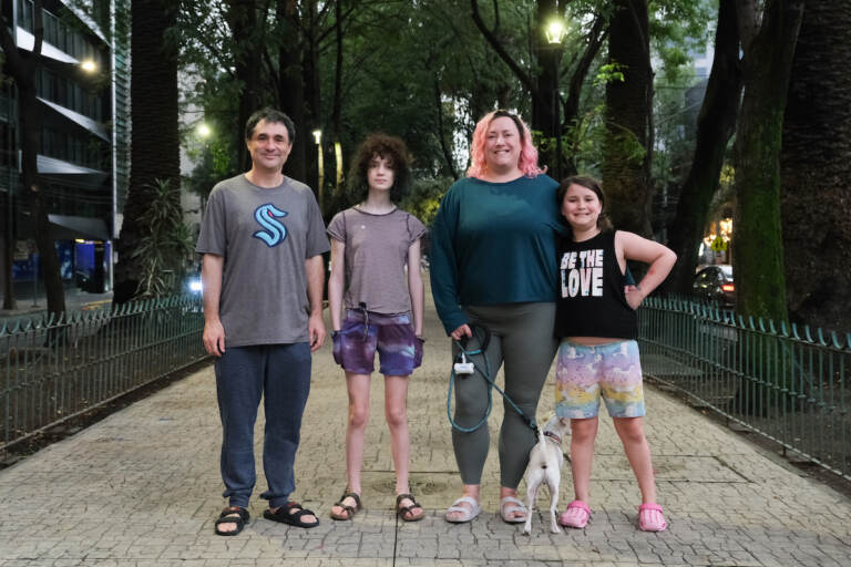 The Bishins family poses with their dog along a pedestrian avenue in Condesa, a neighborhood in Mexico City. (Alan Jinich/WHYY)