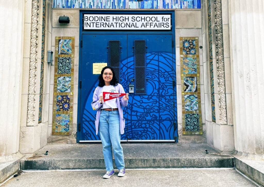 Estrellita Ramirez-Arboleda posing in front of her school.