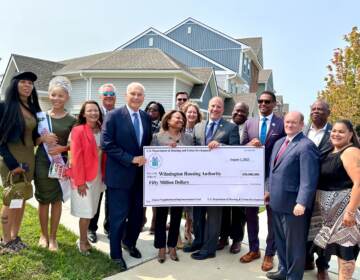Community members and government leaders receiving the $50 million grant from the U.S. Development of Housing and Urban Development.
