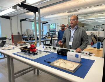 Jorge Rivé demonstrates the company's wireless charging system in a lab.