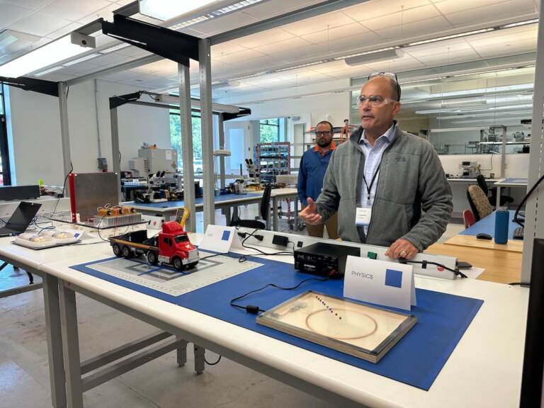 Jorge Rivé demonstrates the company's wireless charging system in a lab.