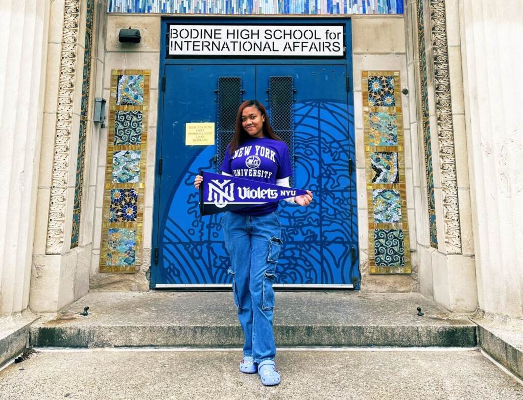 Kaila Randolph-Mitchell posing in front of her school.