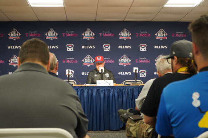 Manager Tom Bradley speaks at a press conference following a Little League World Series game