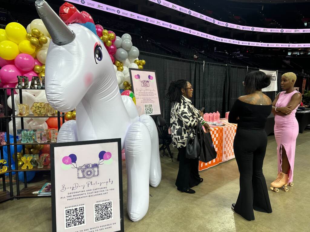 An inflatable unicorn at a booth during the Expo