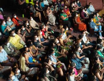 Attendees at the BlackStar Film Festival sit in rows, as seen from above and off to the side.