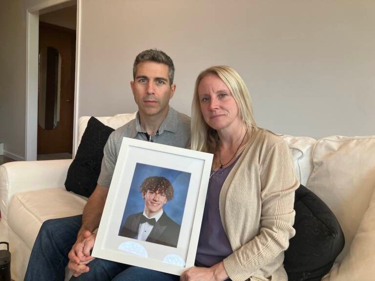 Anthony Allegrini Sr. and Jennifer Allegrini hold a photo of their son, Anthony Allegrini Jr.