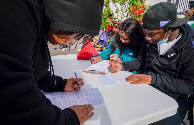 Residents of Brooklyn's Flatbush neighborhood register to vote at a voter registration event on Sept. 29, 2021