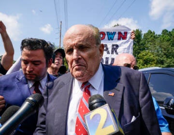 Rudy Giuliani speaks outside the Fulton County jail in Atlanta on Aug. 23, before he surrendered on 13 felony charges related to efforts to try to overturn the 2020 election. Brynn Anderson/AP