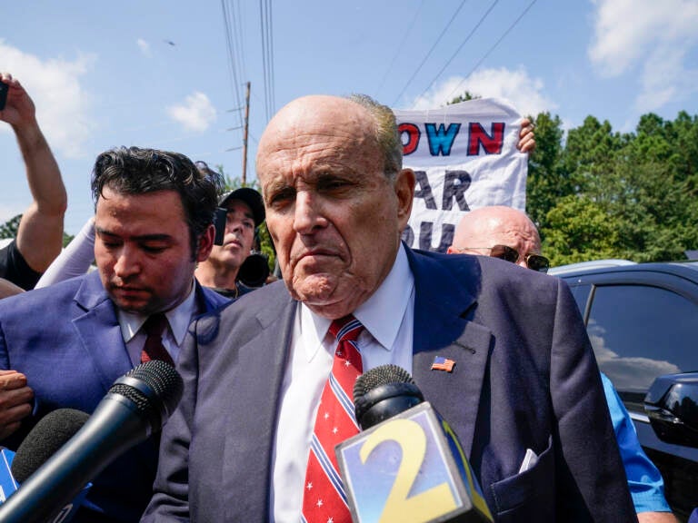 Rudy Giuliani speaks outside the Fulton County jail in Atlanta on Aug. 23, before he surrendered on 13 felony charges related to efforts to try to overturn the 2020 election. Brynn Anderson/AP