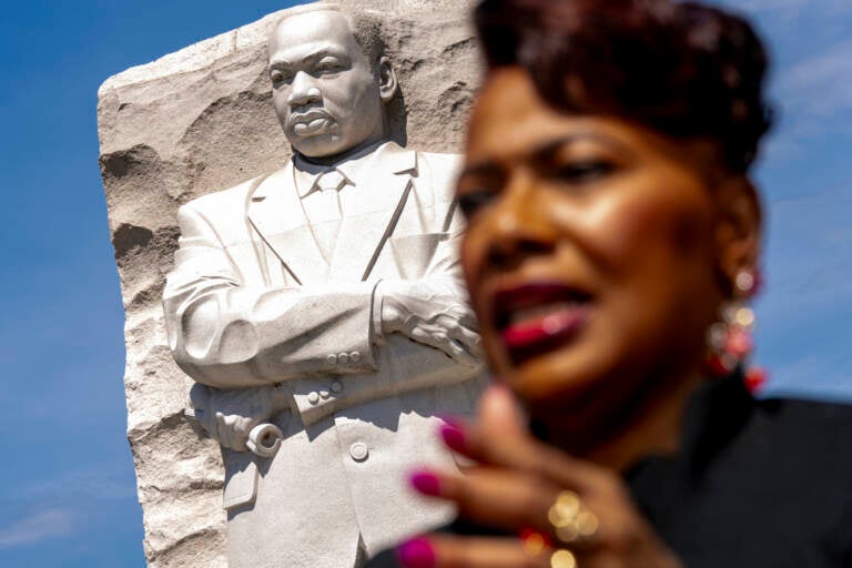 A close-up of Bernice King. A memorial to her father, Martin Luther King Jr., is visible in the background.