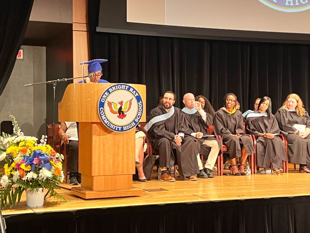 Betty Williams speaking at a podium