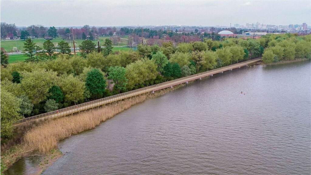 An aerial view of a rendering of a bike trail along a river