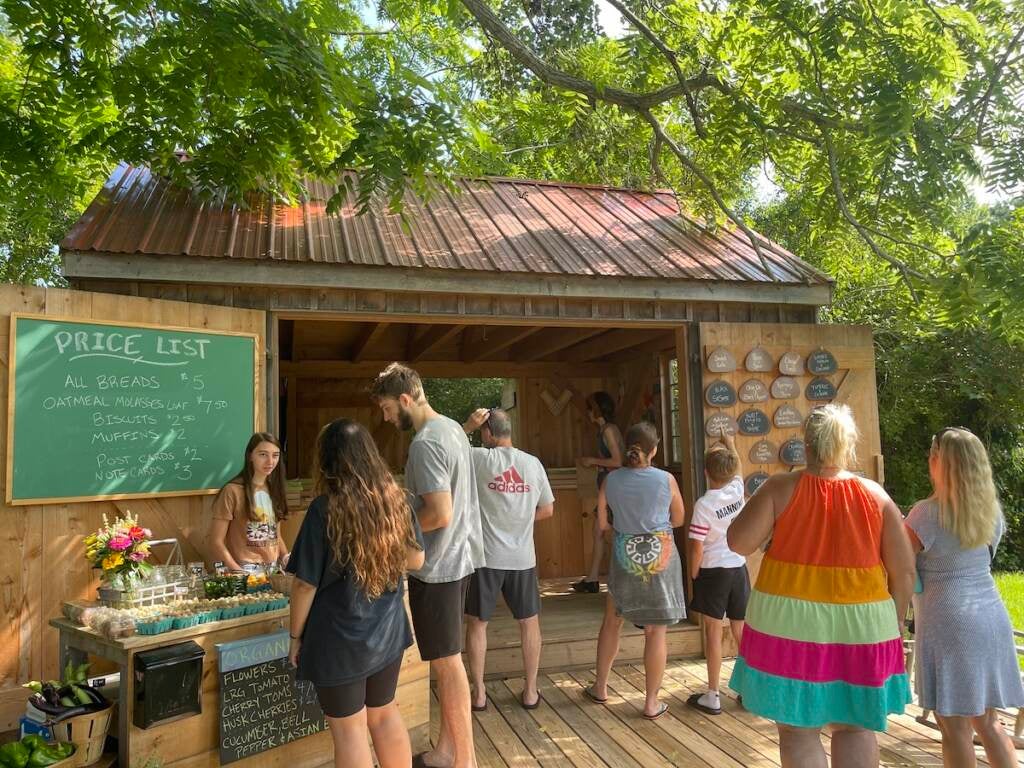 Customers stand outside of Elizabeth Degener's bread stand.